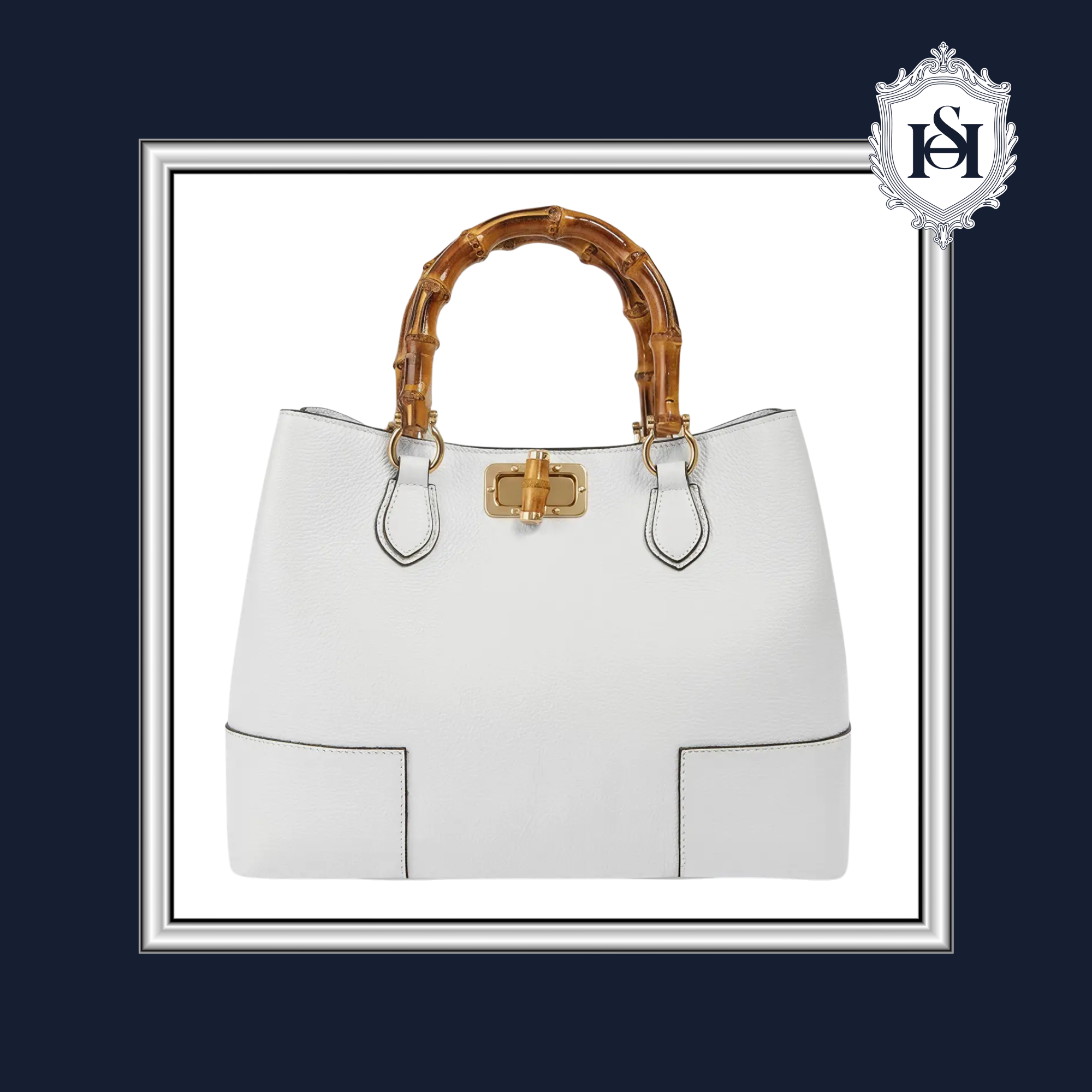 White handbag with bamboo handle on a dark blue background