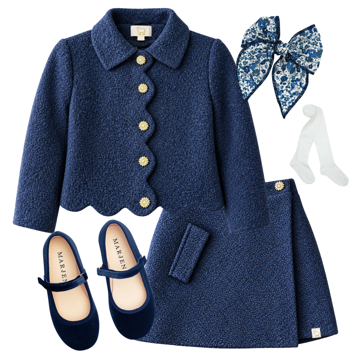 The Geneviève girls' navy tweed jacket and skirt ensemble with a blue and white Liberty floral bow, white tights, and navy velvet Mary Janes
