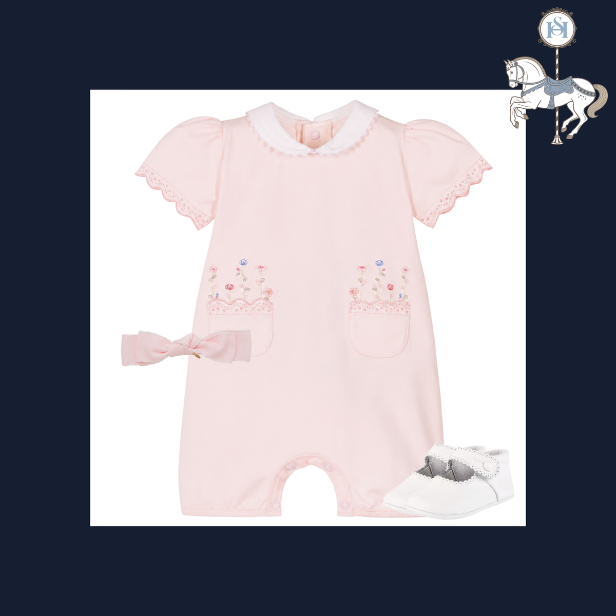 A baby romper set in light pink, featuring short flutter sleeves with lace trim, a white ruffled collar, embroidered floral pockets, a matching pink bow headband, and white booties, all arranged on a white background with a dark navy border.