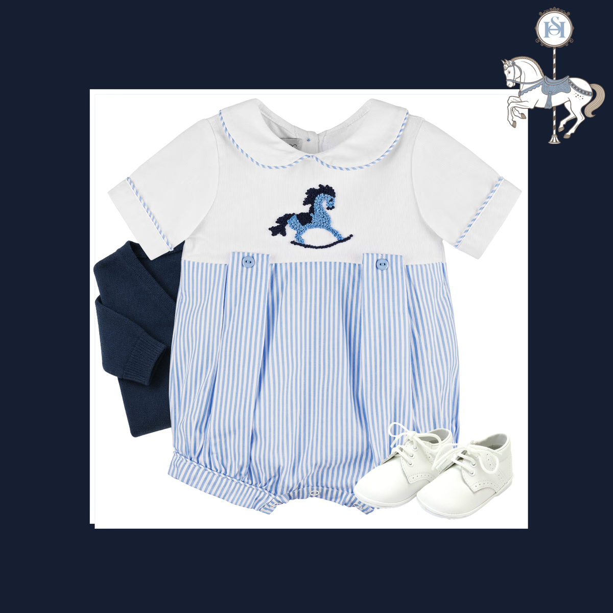 A baby boy's short-sleeve romper set featuring a white top with a blue embroidered rocking horse, blue and white vertical pinstripes on the bottom, a navy blue folded sash, and white lace-up shoes, displayed on a white background with a navy blue border.
