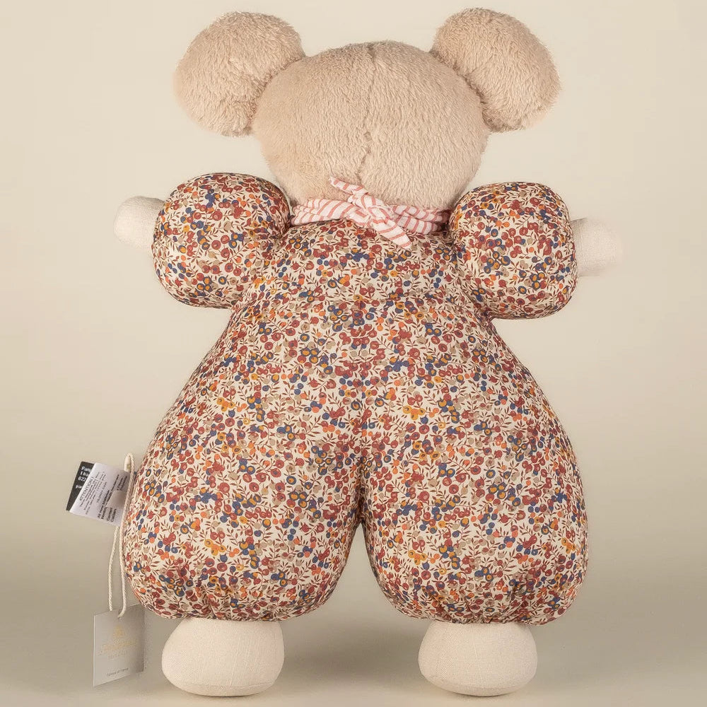 Floral-patterned teddy bear with a plain background